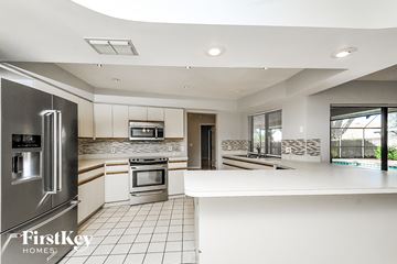 Valrico house for rent - a white kitchen with stainless steel appliances and a white counter top