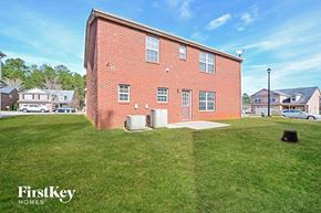 Locust Grove house for rent - A red brick building with a grassy area in front of it.