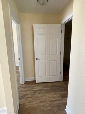 Youngsville apartment for rent - A white door is in the middle of a hallway.