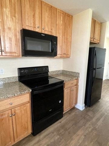 Youngsville apartment for rent - A black stove top oven sitting under a microwave in a kitchen.