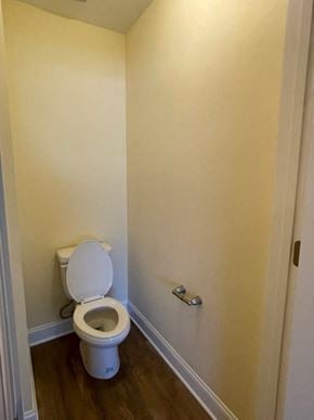 Youngsville apartment for rent - A white toilet in a small room with a door on the right.