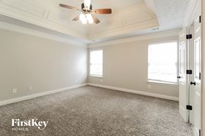 Loganville house for rent - A room with a carpeted floor and a ceiling fan.