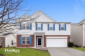 Charlotte house for rent - a white house with blue shutters and a driveway