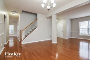 Charlotte house for rent - the foyer and living room of a renovated house with hardwood flooring