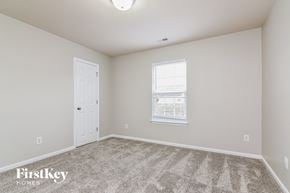 Charlotte house for rent - a bedroom with carpet and a door and a window