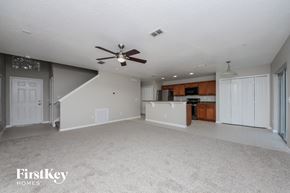 Winter Garden house for rent - A spacious living room with a staircase leading to the upper level.