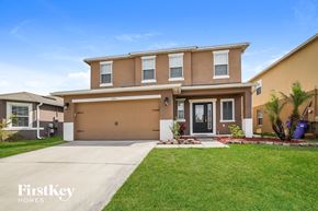 Saint Cloud house for rent - a house with a garage door and a lawn