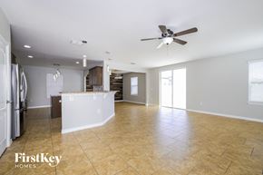 Saint Cloud house for rent - an empty kitchen and living room with a ceiling fan