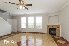 Spring house for rent - A spacious living room with a fireplace and a ceiling fan.