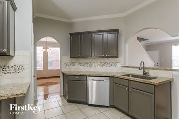 Spring house for rent - A kitchen with a washer and dryer built into the cabinetry.