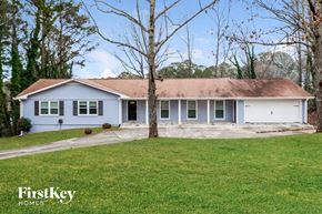 Snellville house for rent - a blue and white house with a yard and a tree