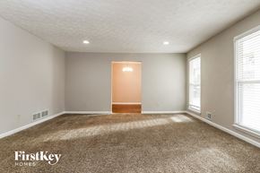 Snellville house for rent - a living room with a carpeted floor and two windows