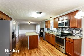 Snellville house for rent - a kitchen with wooden cabinets and stainless steel appliances