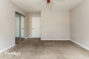 Snellville house for rent - a bedroom with a carpeted floor and a mirrored closet