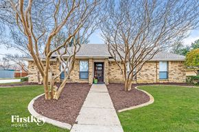 Carrollton house for rent - A house with a brown brick exterior and a stone pathway leading to the front door.