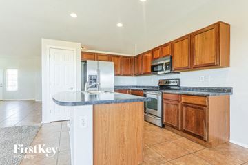 San Tan Valley house for rent - A kitchen with wooden cabinets and a granite countertop.