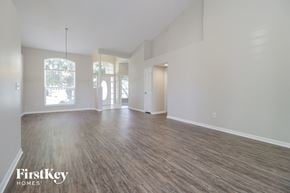Orlando house for rent - A spacious room with wooden flooring and white walls.