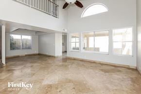 Glendale house for rent - A spacious room with a fan and large windows.
