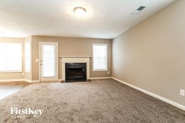 Duluth house for rent - a living room with a fireplace and a carpet