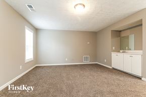 Duluth house for rent - an empty room with carpet and a sink and a mirror