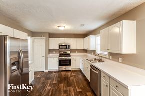 Duluth house for rent - a kitchen with white cabinets and stainless steel appliances