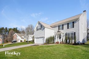 Jamestown house for rent - two story house with white siding and a yard with grass