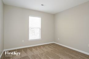 Jamestown house for rent - a spacious room with carpet and a window