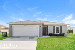 Port St. Lucie house for rent - A house with a garage and a driveway is for sale.