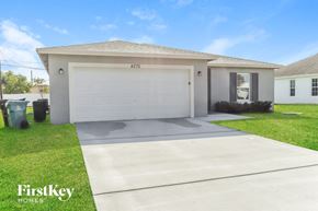 Port St. Lucie house for rent - A house with a garage door numbered 215 is for sale.