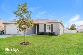 Port St. Lucie house for rent - A house with a tree in front of it.