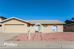 Glendale house for rent - a beige house with a driveway and a garage door