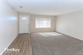 Glendale house for rent - a spacious living room with white walls and wood flooring