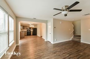 San Antonio house for rent - an empty living room and kitchen with a ceiling fan