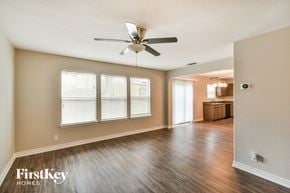 San Antonio house for rent - an empty living room with wood floors and a ceiling fan