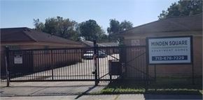 Houston apartment for rent - A gated entrance to a property with a sign that says Minden Square Apartment Homes.