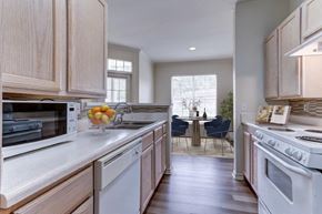 Lafayette apartment for rent - a kitchen with white appliances and wooden cabinets