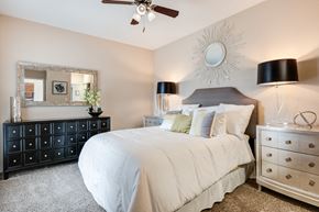 Cincinnati apartment for rent - a bedroom with a large white bed and a sunburst mirror