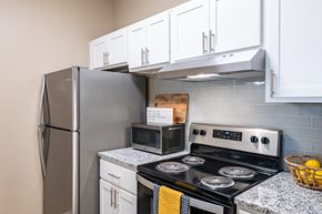 Shreveport apartment for rent - a kitchen with stainless steel appliances and white cabinets