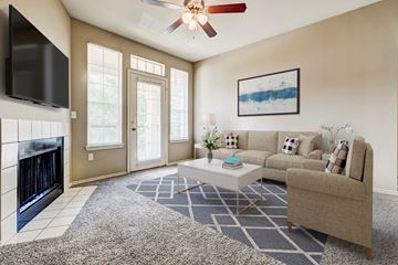 Shreveport apartment for rent - a living room with a couch and a coffee table and a fireplace