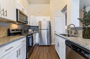 Lafayette apartment for rent - a kitchen with white cabinets and a stainless steel refrigerator