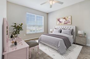 Lafayette apartment for rent - a bedroom with a bed and a ceiling fan