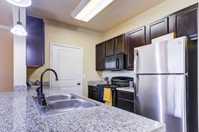 Lafayette apartment for rent - a kitchen with stainless steel appliances and granite counter tops