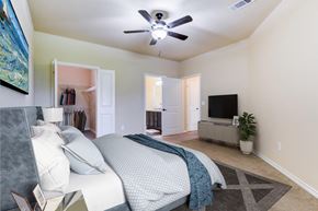 Lafayette apartment for rent - a bedroom with a bed and a ceiling fan