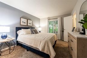 Fairfield apartment for rent - a bedroom with a bed and a dresser and a window