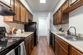 Fairfield apartment for rent - a kitchen with wooden cabinets and a stove and a sink