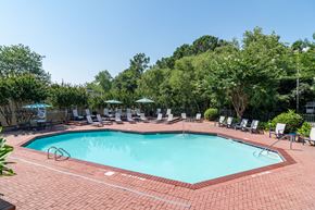 Norcross apartment for rent - a swimming pool with chairs and umbrellas at the resort