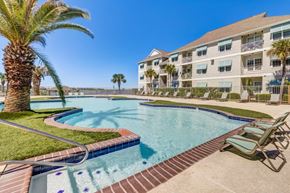 Slidell apartment for rent - a large swimming pool with a building in the background