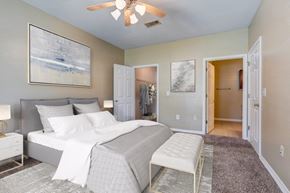 Slidell apartment for rent - a bedroom with a bed and a ceiling fan