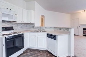 Valparaiso apartment for rent - A kitchen with white cabinets and a black stove top.