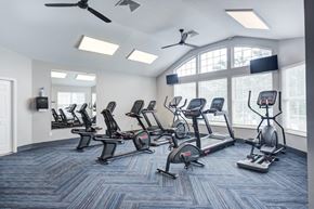 Valparaiso apartment for rent - A gym with treadmills, elliptical machines, and a fan.